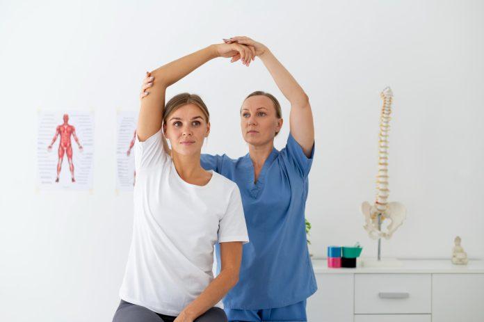 physiotherapist-helping-female-patient-her-clinic