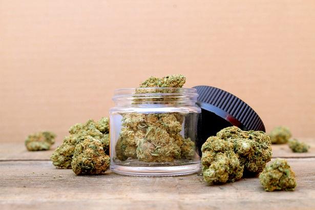 Marijuana in Open Jar Surrounded by Buds - Centered (Green Crack, Sativa Dominant Hybrid Straint)